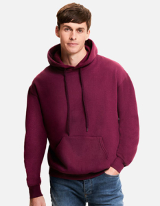 En mand iført en bordeaux hættetrøje står afslappet med den ene hånd i lommen, mod en hvid baggrund. Han bærer også blå jeans.