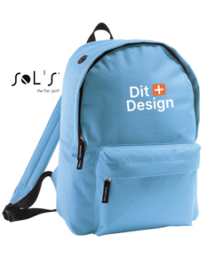 Rygsæk er lyseblå med teksten "Dit Design" trykt foran. Den har lynlåslomme og bærestrop, placeret mod en hvid baggrund. Der står "SOL'S the fair spirit" øverst.