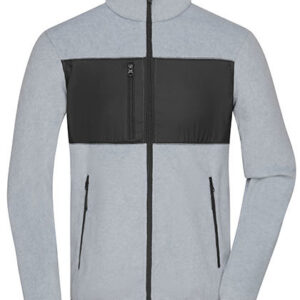 Grå sweatshirt med lynlås og sort panel på brystet hænger flat. Lynlåslommer er synlige på hver side. Baggrund er enkel og ensfarvet. Ingen tekst til stede.