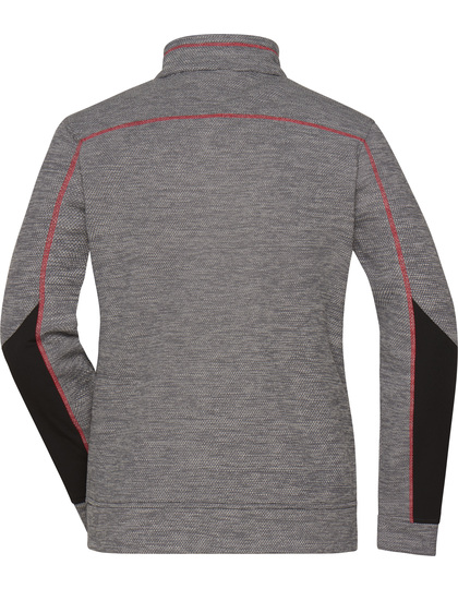Grå trøje med sorte paneler langs armene, hænger i tomt rum. Den har en enkel, sporty stil med røde syninger, uden synlig tekst.