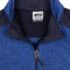 Blå sweater med lynlås halvt åben ses. Omkring lynlåsen er der mørkere stof. Sweaterens mærkeoplysninger ses på en hvid etiket indeni nakken: "Men's Collection, XX Large".