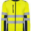 Jakke viser en neongul, refleksbånd-belagt softshell jakke med lynlås og lommer. Den har mørkeblå detaljer, velegnet til synlighed i arbejdskontekster. Ingen tekst er til stede.