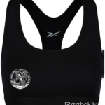 Sports-bh i sort design, prydet med Reebok-logoet foran. Grafisk symbol med teksten "FRANK'S DANCE STUDIO" på venstre side. Baggrund er enkel og neutral.