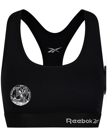 Sports-bh i sort design, prydet med Reebok-logoet foran. Grafisk symbol med teksten "FRANK'S DANCE STUDIO" på venstre side. Baggrund er enkel og neutral.